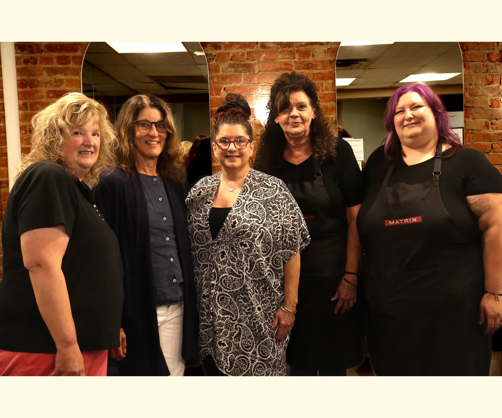 The Scissor Joint team together inside the salon